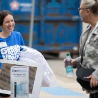 Melissa Ellis carrying items while chatting with new arrivals